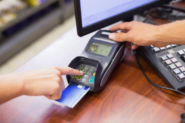 istock Woman paying with her credit card and doing his pin code 691669944