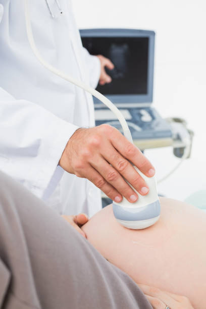 istock Pregnant woman having a sonagram scan 691670294