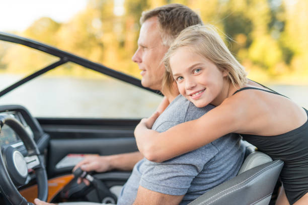 istock Cute daughter hugs her father on boat 691676020