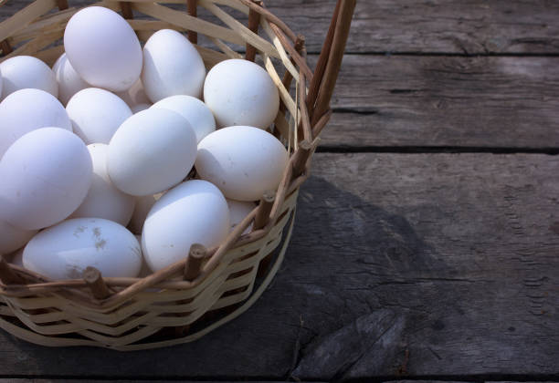 istock Homemade white eggs in a basket on a wooden background 691678440