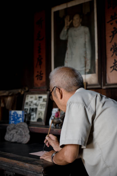 istock Senior Chinese man writing characters 691678730