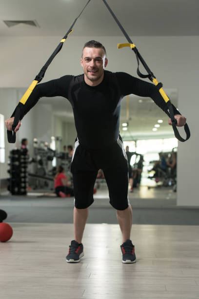 istock Young Attractive Man Training With Trx Fitness Straps 691680496