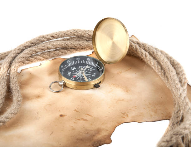 istock Old compass and paper isolated on white background 691685298