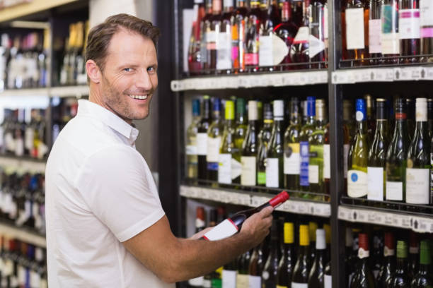istock Portrait of a smiling handsome having a wine bottle in her hands 691685444