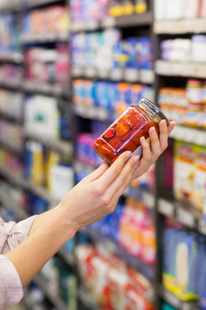 istock A pretty woman showing a jar 691690374