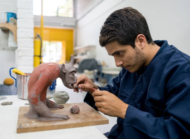 Design student at the university in a pottery class