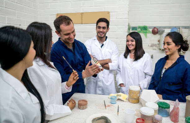 istock Group of design students at a pottery class with their teacher 691693160