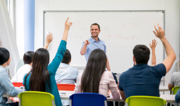istock Students in class raising their hands to ask questions 691693208