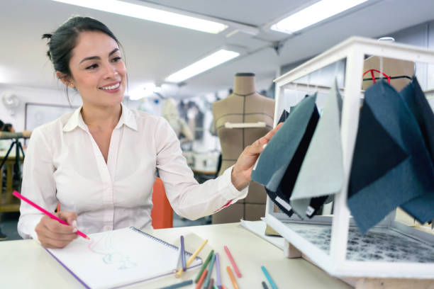 istock Fashion designer student looking at fabrics 691693308