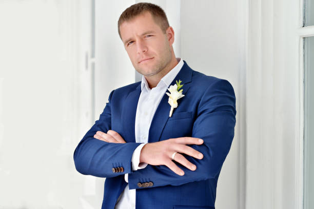 istock Handsome groom in suit on the nature 691693766
