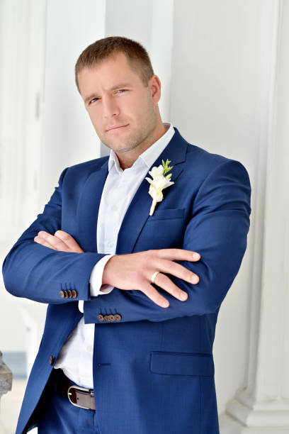 istock Handsome groom in suit on the nature 691693794