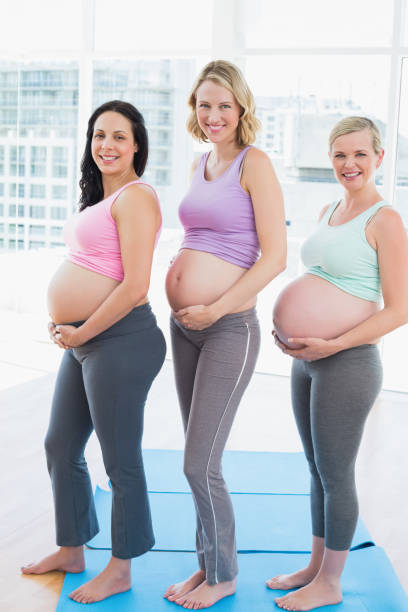 istock Smiling pregnant women standing in a row 691694068