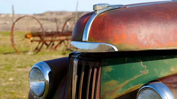Rusty chrome finished Studebaker left abandoned in a field
