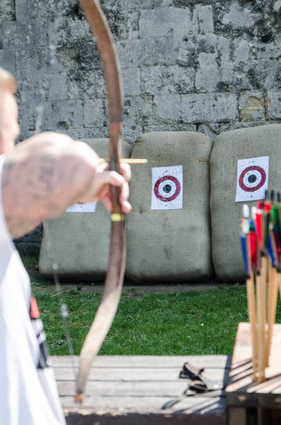 istock Man aiming arrow using a bow to hit target at the Budapest Citadel 691700864