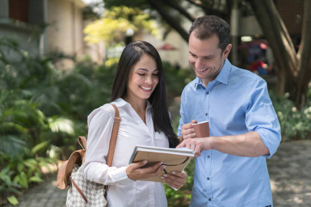 istock Happy student talking to her teacher at the university 691703462