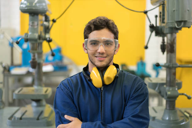 Portrait of an engineering student at the university Portrait of an engineering student at the university wearing protective wear and smiling - education concepts industrial designer stock pictures, royalty-free photos & images