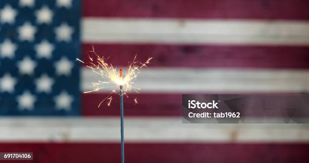 Glowing Sparkler With Rustic Wooden Flag Of United States Of America Stock Photo - Download Image Now