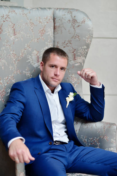 istock Handsome groom in suit in the hall 691706404
