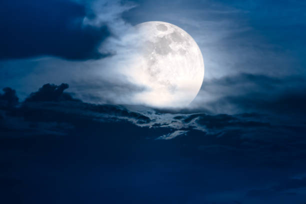 istock Nighttime sky with clouds and bright super moon with shiny. 691718790