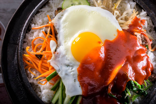 istock BI Bim Bap, Rice with Mixed Vegetables, top view with Hot Sauce in Cast Iron Pot 691718792