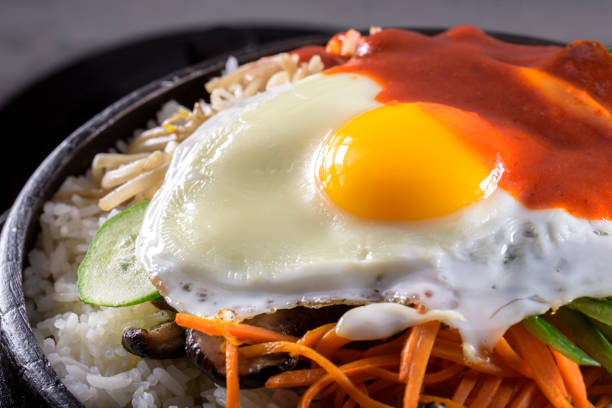 istock BI Bim Bap, Rice with Mixed Vegetables, top view with Hot Sauce in Cast Iron Pot 691718808