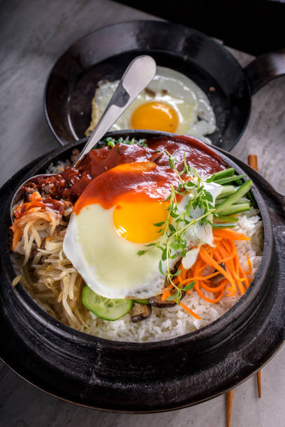istock BI Bim Bap, Rice with Mixed Vegetables, top view with Hot Sauce in Cast Iron Pot 691718854
