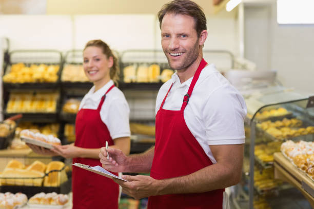 istock Portrait of a two smiling bakers looking at camera 691719248