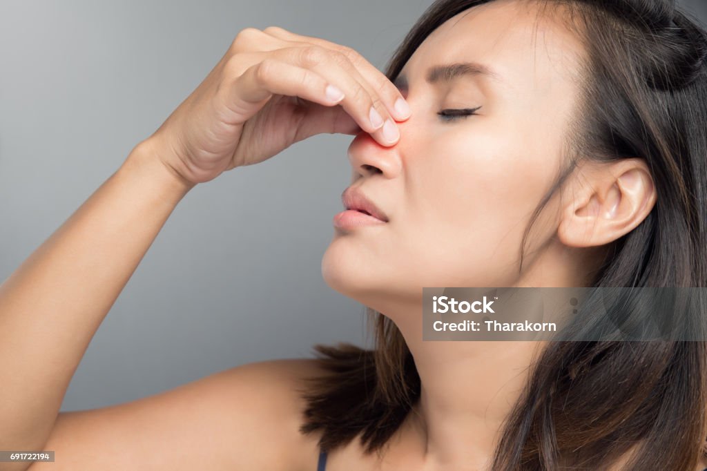 The asian woman hurts her nose because she has cold. Nose Stock Photo