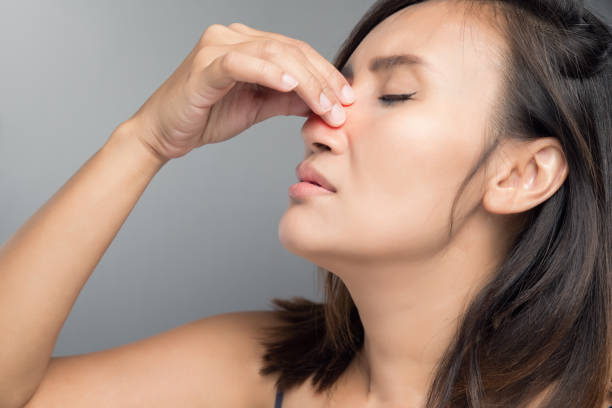 The asian woman hurts her nose because she has cold. stock photo