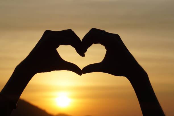 istock silhouette hand gesture feeling love during sunset 691723626