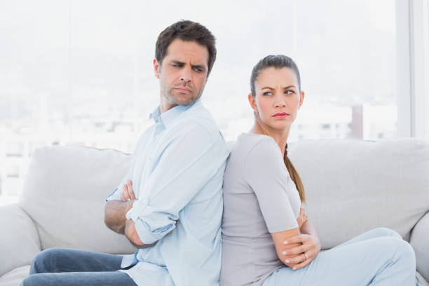 istock Angry couple sitting back-to-back on the couch 691729924