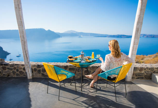 istock Woman enjoying breakfast with beautiful view from terrace 691738404