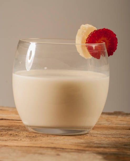 istock Fresh milk on wooden table over wall background 691744150