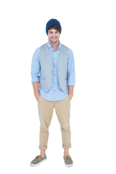 Handsome hipster with hands in pocket looking at camera on white background