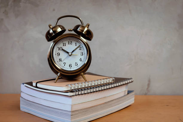 istock alarm clock and book with vintage wall 691754268