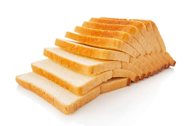 The cut loaf of white bread with reflection on white