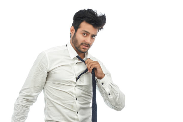 istock young man in shirt and tie touching untying his necktie 691755176