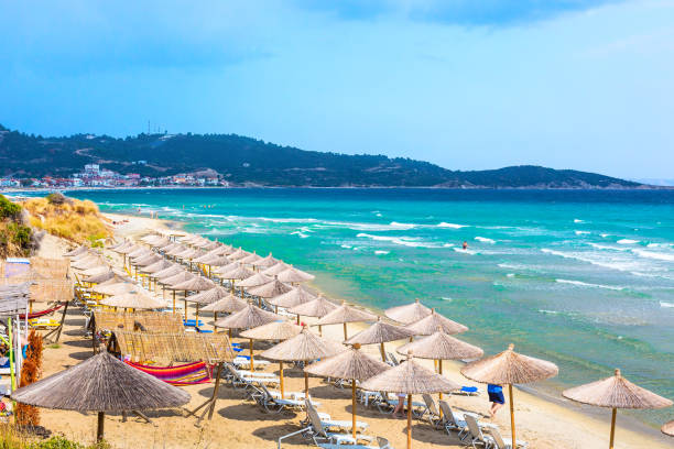 istock beach background with turquoise sea water waves and umbrellas, Greece 691755292