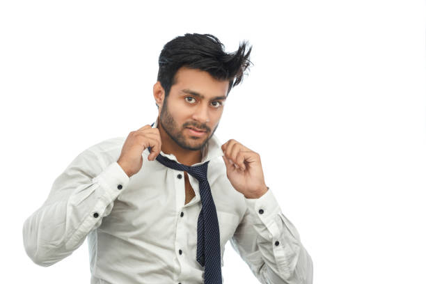 istock young man in shirt and tie touching untying his necktie 691755320