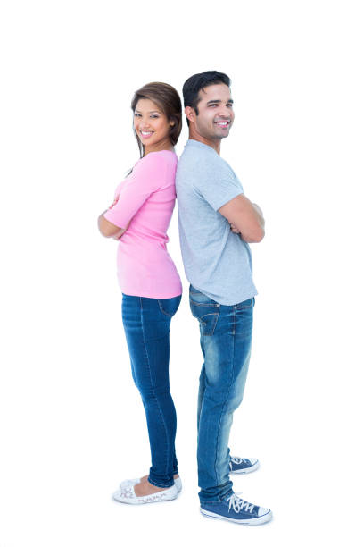 istock Happy couple standing back to back 691757636