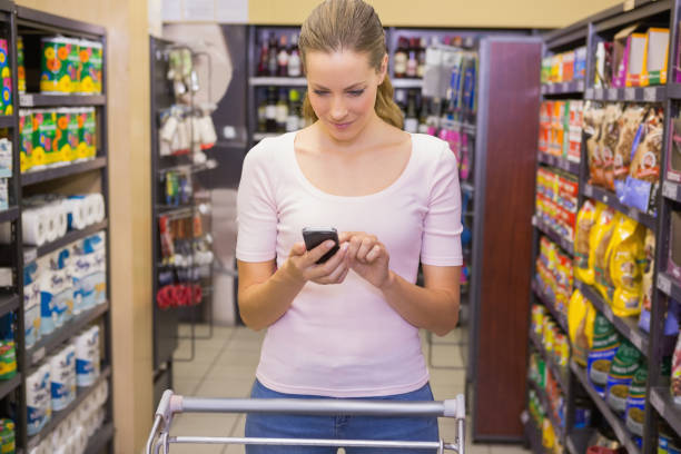 istock Pretty blonde woman using smartphone 691757762