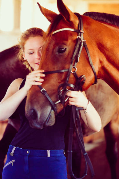 istock Woman hugging brown horse in stable 691761158