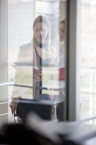 istock Businesswomen talking in office 691761290