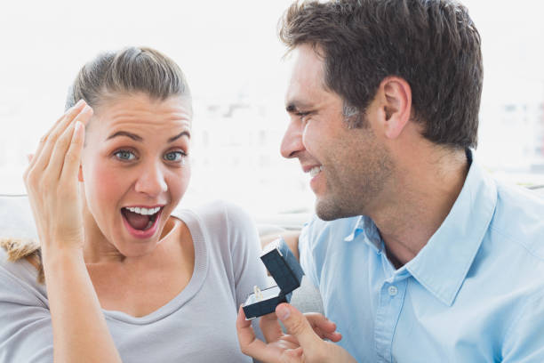istock Delighted young couple getting engaged on the sofa 691761342