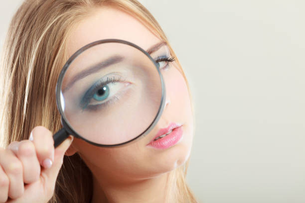 istock girl holding on eye magnifying glass loupe 691765748