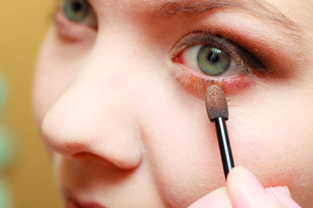 istock Close up woman getting make up, eyeshadow 691768704