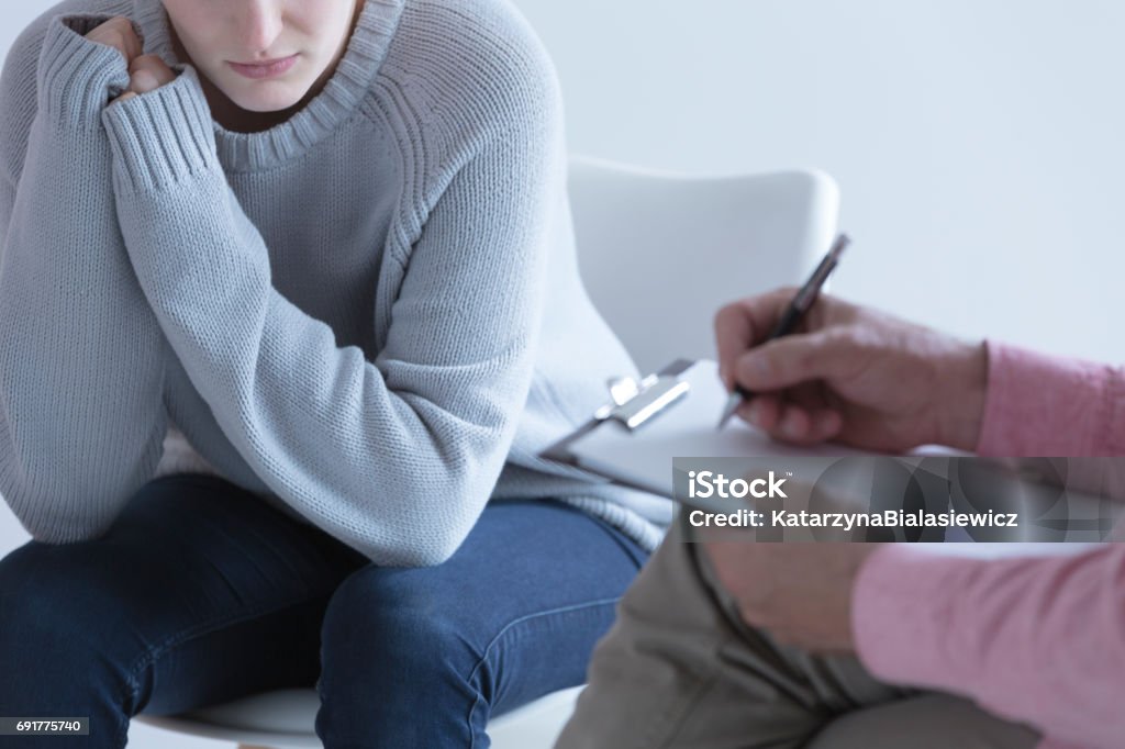 Girl during session with psychotherapist Young girl during session with her psychotherapist Abortion Stock Photo