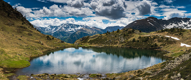 Wide panoramic vista over Tristaina lake in Pyrenees,Andorra