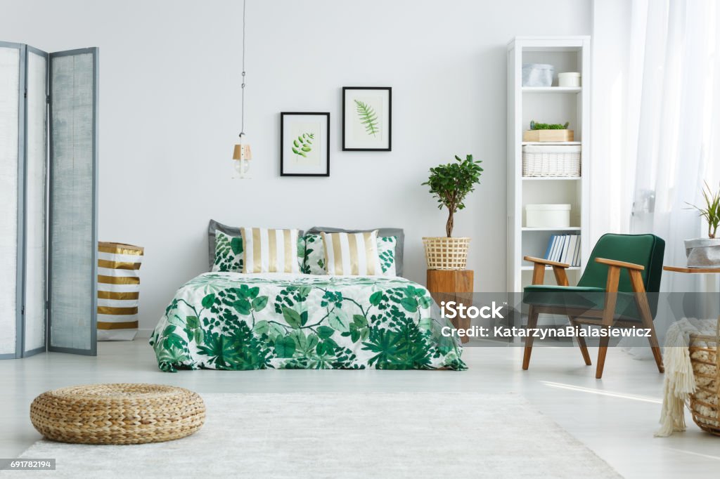 Bedroom with screen, bed, armchair White bedroom with screen, bed, armchair, bookcase, lamp and pouf Bedroom Stock Photo