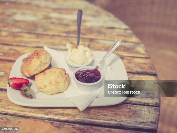 Vintage Filtered Shot Of Cream Tea On Table Stock Photo - Download Image Now - Afternoon Tea, Bread, Bun - Bread